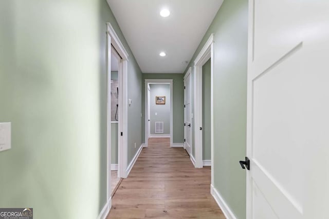 hall featuring baseboards, recessed lighting, visible vents, and light wood-type flooring