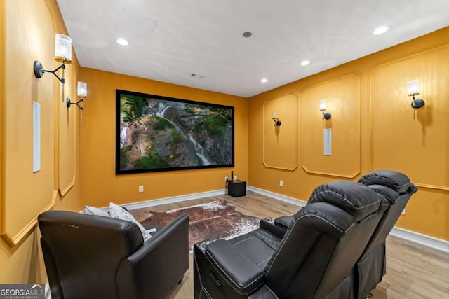 home theater room with visible vents, baseboards, wood finished floors, and recessed lighting