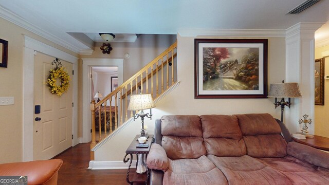living room featuring wood finished floors, visible vents, crown molding, and stairs