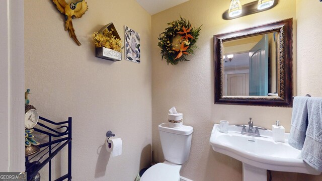 bathroom with toilet and a sink