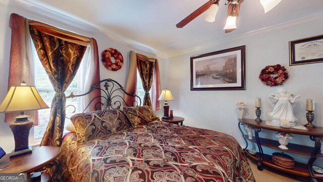 bedroom with a ceiling fan, ornamental molding, and carpet flooring