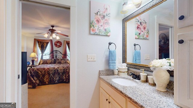 bathroom featuring ceiling fan, vanity, connected bathroom, and ornamental molding