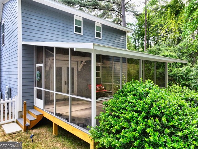 view of home's exterior with a sunroom