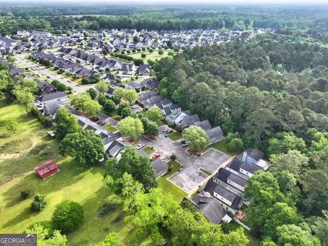 birds eye view of property featuring a forest view and a residential view