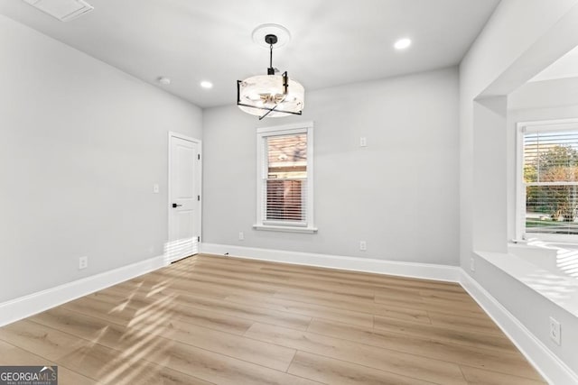 unfurnished dining area featuring recessed lighting, light wood-type flooring, visible vents, and baseboards