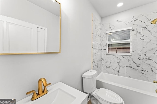 bathroom featuring recessed lighting, toilet, bathtub / shower combination, and a sink