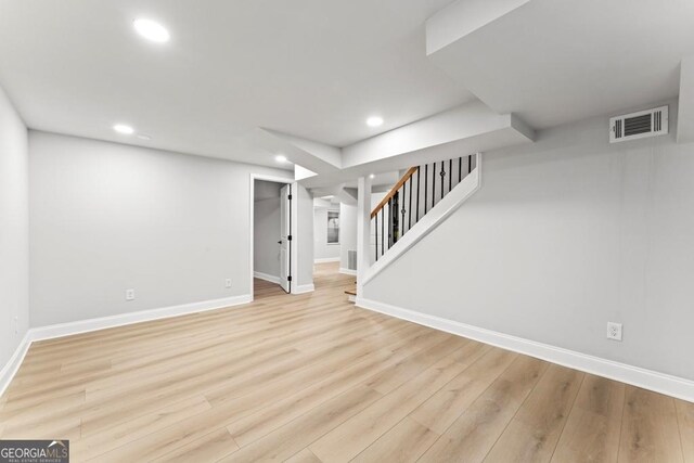 finished basement with baseboards, light wood-style flooring, visible vents, and recessed lighting