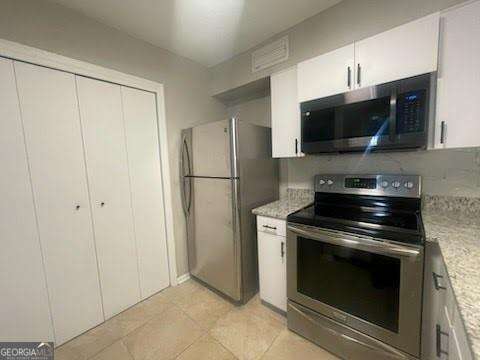 kitchen featuring white cabinetry and stainless steel appliances