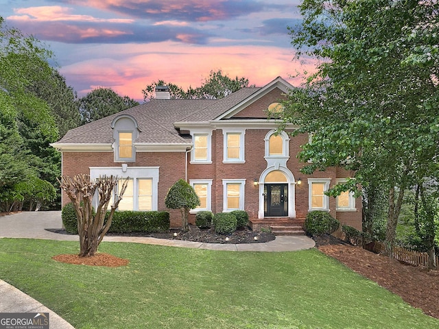 515 Old Chartwell Xing, Alpharetta, GA 30022 - colonial house featuring a lawn, brick siding, fence, and a chimney