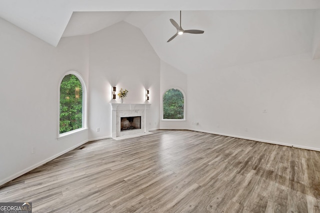 515 Old Chartwell Xing, Alpharetta, GA 30022 - unfurnished living room featuring wood finished floors, baseboards, ceiling fan, high vaulted ceiling, and a high end fireplace
