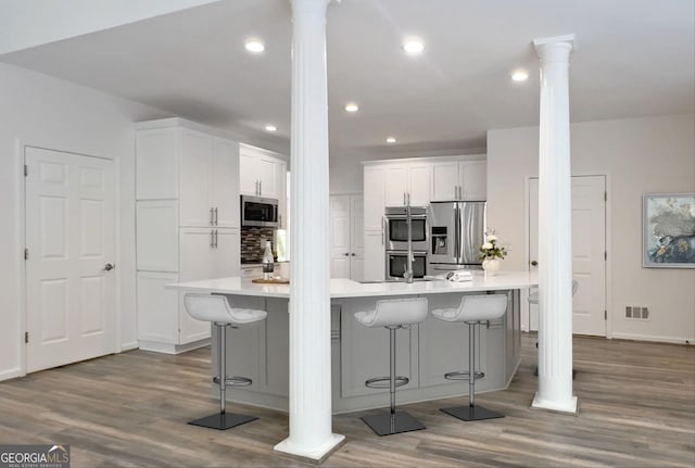 515 Old Chartwell Xing, Alpharetta, GA 30022 - kitchen featuring ornate columns, dark wood-style flooring, visible vents, and stainless steel appliances