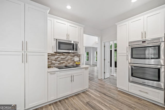 515 Old Chartwell Xing, Alpharetta, GA 30022 - kitchen featuring white cabinets, appliances with stainless steel finishes, light wood finished floors, recessed lighting, and backsplash