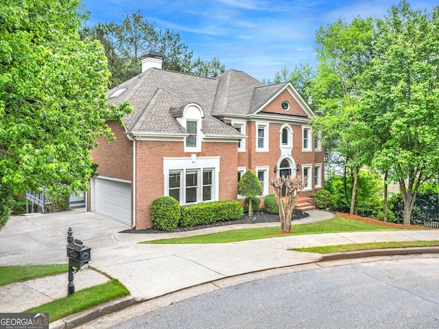 515 Old Chartwell Xing, Alpharetta, GA 30022 - view of front of property with roof with shingles, a chimney, brick siding, concrete driveway, and an attached garage