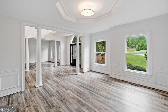 515 Old Chartwell Xing, Alpharetta, GA 30022 - unfurnished living room with a raised ceiling, ornamental molding, decorative columns, and wood finished floors
