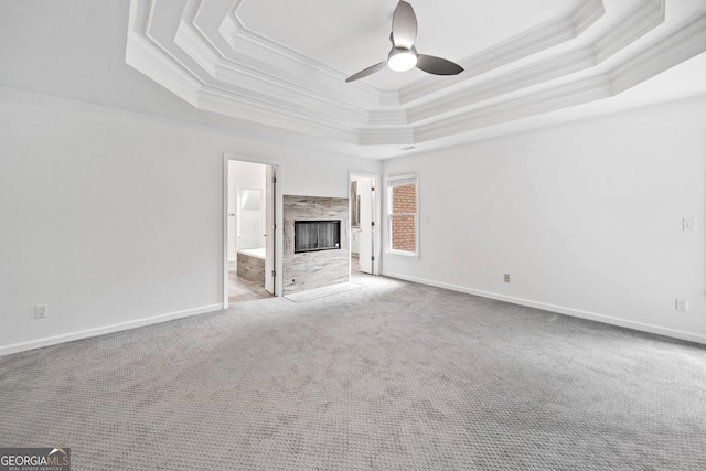 515 Old Chartwell Xing, Alpharetta, GA 30022 - unfurnished living room featuring a ceiling fan, a raised ceiling, baseboards, ornamental molding, and carpet flooring