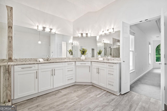 515 Old Chartwell Xing, Alpharetta, GA 30022 - full bath with double vanity, a tile shower, wood finished floors, a sink, and baseboards