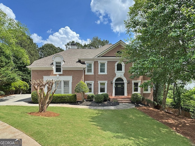 515 Old Chartwell Xing, Alpharetta, GA 30022 - view of front of home featuring brick siding, fence, a chimney, and a front lawn