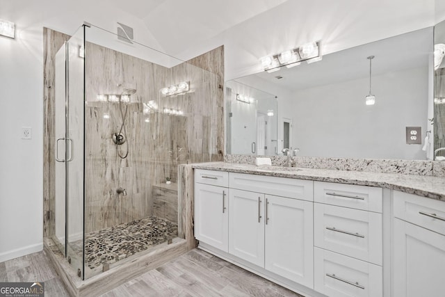 515 Old Chartwell Xing, Alpharetta, GA 30022 - bathroom featuring vanity, a stall shower, wood finished floors, and lofted ceiling