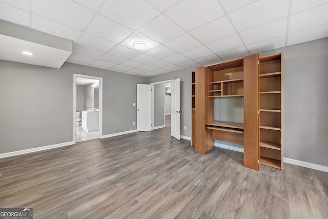 515 Old Chartwell Xing, Alpharetta, GA 30022 - unfurnished living room featuring baseboards, a drop ceiling, and wood finished floors