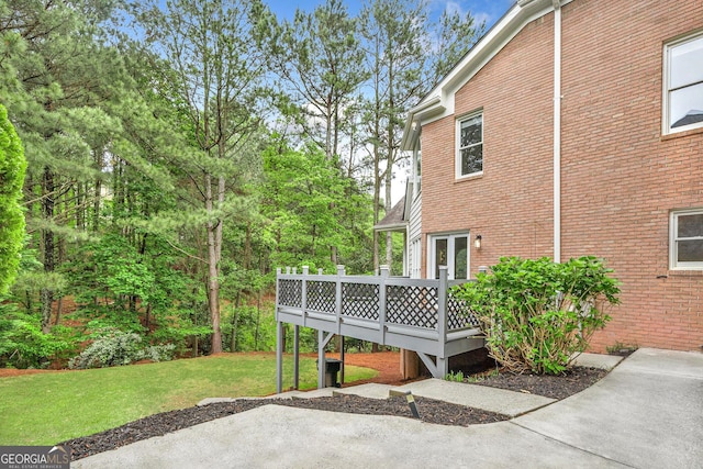 515 Old Chartwell Xing, Alpharetta, GA 30022 - view of side of property with a lawn, a wooden deck, brick siding, and a patio