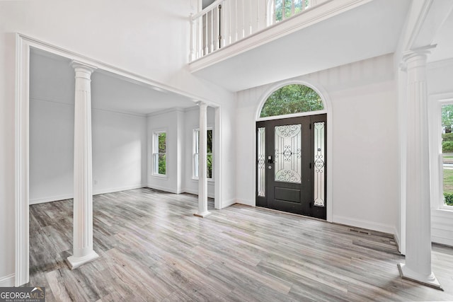 515 Old Chartwell Xing, Alpharetta, GA 30022 - entryway with decorative columns, wood finished floors, and a towering ceiling
