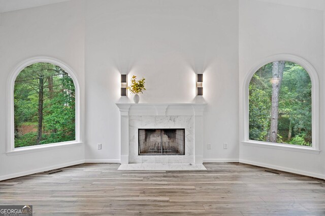 515 Old Chartwell Xing, Alpharetta, GA 30022 - unfurnished living room featuring baseboards, visible vents, wood finished floors, and a fireplace