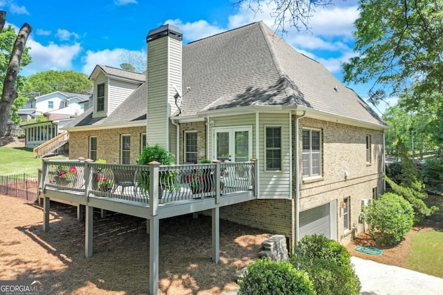 200 Piedmont Ave, Gainesville, GA 30501 - rear view of property with an attached garage, a chimney, brick siding, and a deck