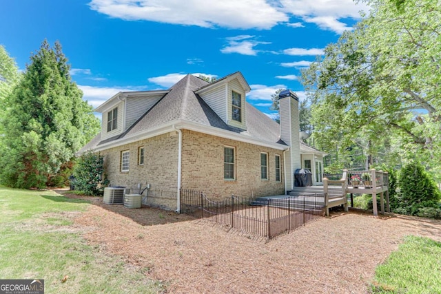 200 Piedmont Ave, Gainesville, GA 30501 - view of side of property with roof with shingles, cooling unit, a chimney, brick siding, and a wooden deck