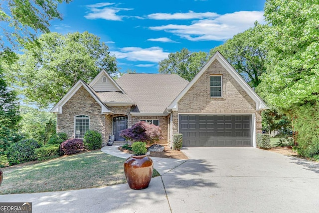 200 Piedmont Ave, Gainesville, GA 30501 - view of front of house with a shingled roof, concrete driveway, stone siding, a front yard, and a garage