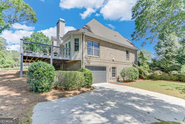 200 Piedmont Ave, Gainesville, GA 30501 - back of house featuring a chimney, driveway, a deck, an attached garage, and brick siding