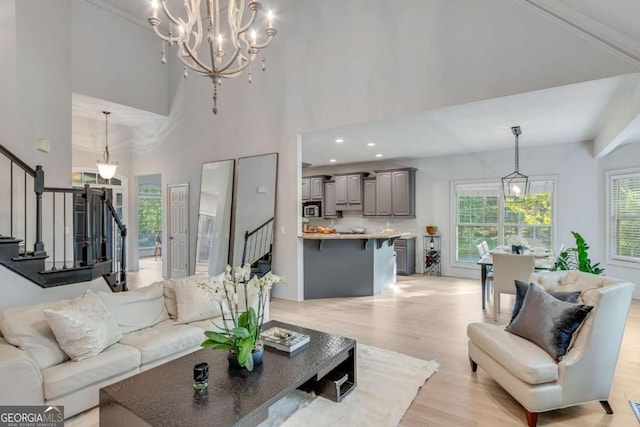 200 Piedmont Ave, Gainesville, GA 30501 - living area with stairway, a high ceiling, a notable chandelier, and light wood finished floors