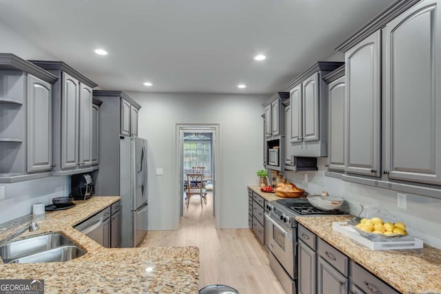 200 Piedmont Ave, Gainesville, GA 30501 - kitchen featuring light wood-type flooring, appliances with stainless steel finishes, a sink, and gray cabinetry
