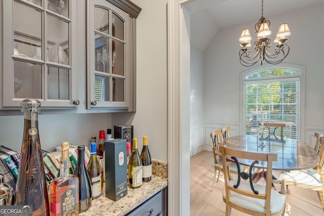 200 Piedmont Ave, Gainesville, GA 30501 - interior space featuring a chandelier, light wood-style flooring, pendant lighting, and wainscoting