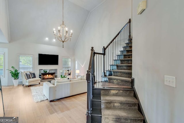 200 Piedmont Ave, Gainesville, GA 30501 - stairs with high vaulted ceiling, an inviting chandelier, wood finished floors, and a fireplace