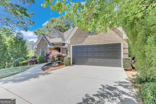 200 Piedmont Ave, Gainesville, GA 30501 - view of front of house with stone siding, driveway, and a garage