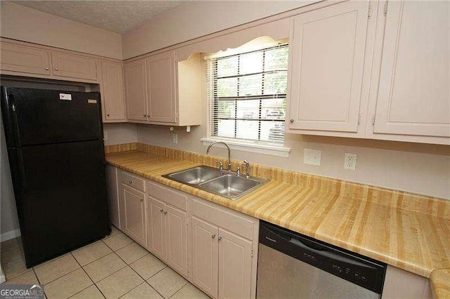 3540 Tarragon Dr, Decatur, GA 30034 - kitchen with light countertops, dishwasher, light tile patterned floors, a sink, and freestanding refrigerator