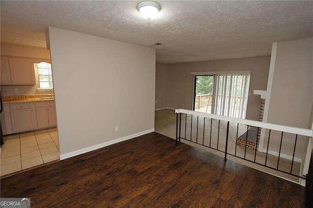 3540 Tarragon Dr, Decatur, GA 30034 - unfurnished room with light wood-type flooring, a textured ceiling, baseboards, and a sink