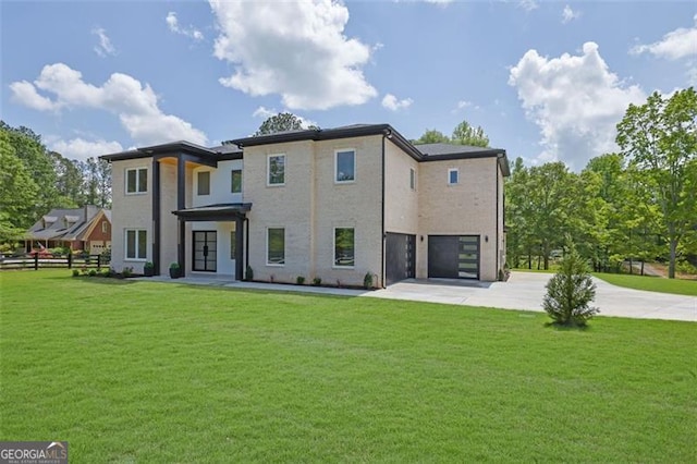 4881 Bill Cheek Rd, Auburn, GA 30011 - back of property with concrete driveway, a lawn, and a garage