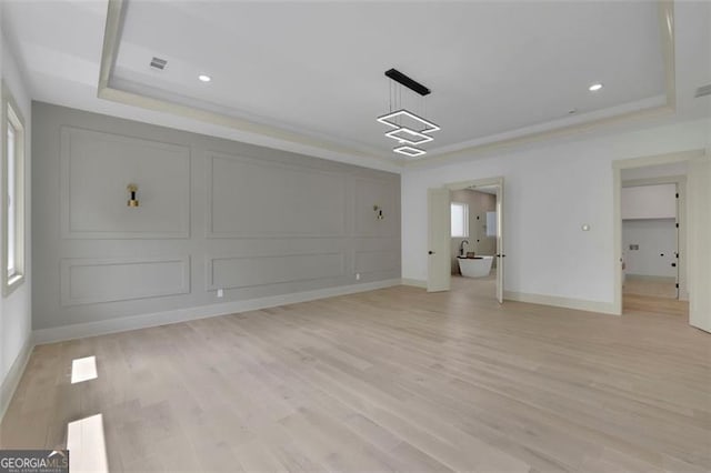 4881 Bill Cheek Rd, Auburn, GA 30011 - interior space featuring light wood-style flooring, a tray ceiling, visible vents, baseboards, and recessed lighting