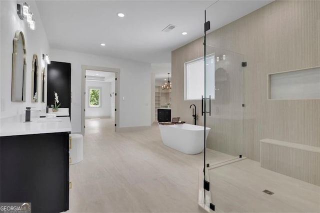 4881 Bill Cheek Rd, Auburn, GA 30011 - full bath featuring a soaking tub, a stall shower, visible vents, recessed lighting, and vanity