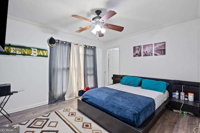 3999 Wabash Ln, Ellenwood, GA 30294 - bedroom with wood finished floors, ceiling fan, and ornamental molding