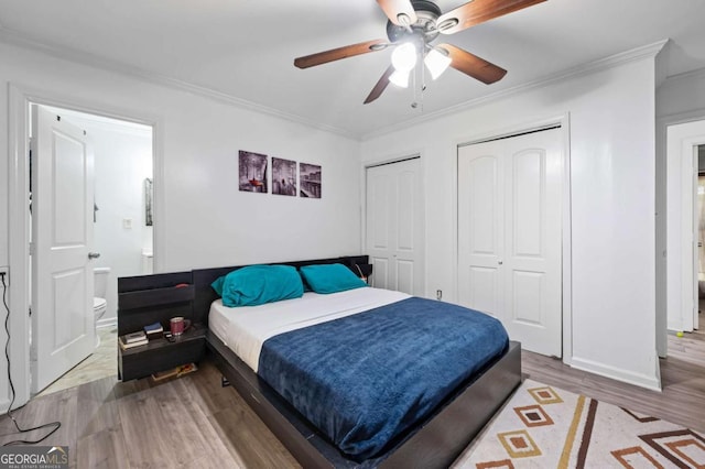 3999 Wabash Ln, Ellenwood, GA 30294 - bedroom featuring a ceiling fan, crown molding, wood finished floors, multiple closets, and baseboards