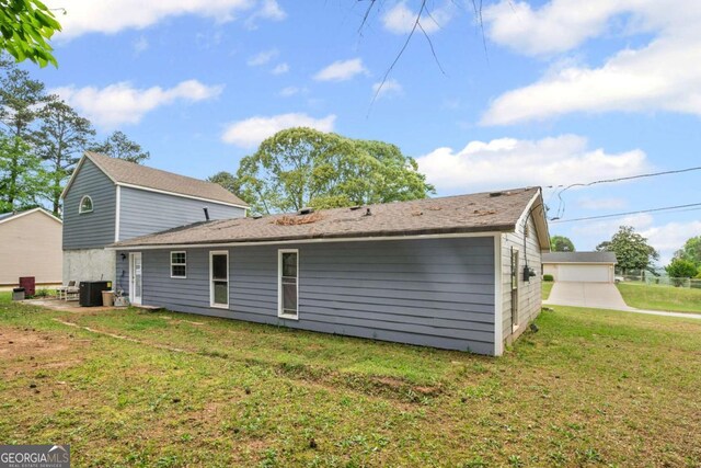 3999 Wabash Ln, Ellenwood, GA 30294 - rear view of property with central air condition unit, a patio area, and a lawn