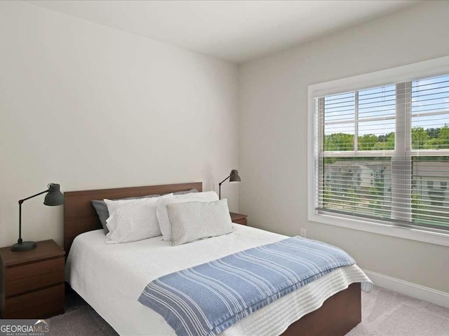 carpeted bedroom with baseboards