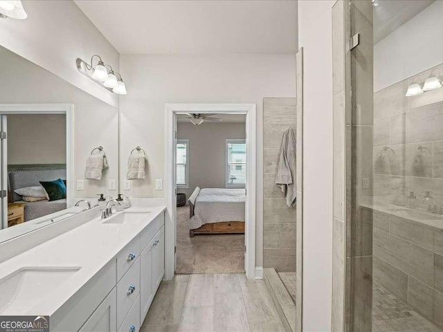bathroom with ensuite bath, a ceiling fan, and a sink