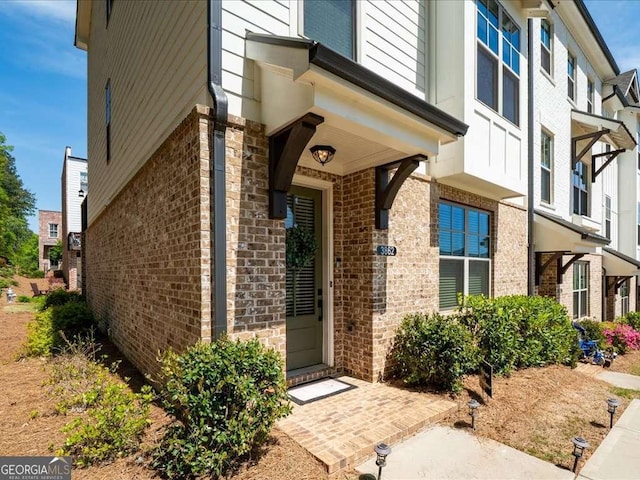 entrance to property featuring brick siding