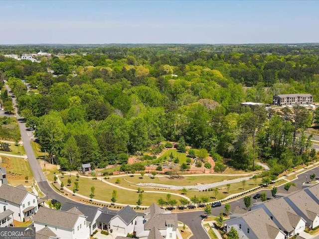 birds eye view of property featuring a forest view