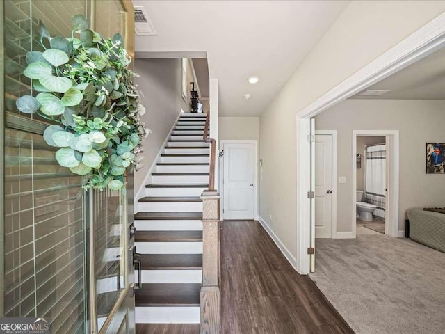 stairs with baseboards, wood finished floors, visible vents, and recessed lighting