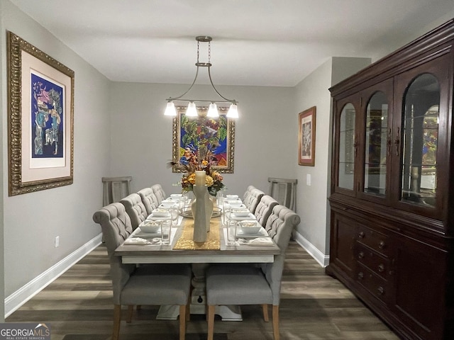 dining space featuring baseboards and dark wood finished floors