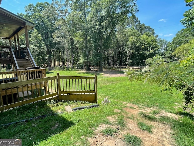 view of yard with a deck and stairs